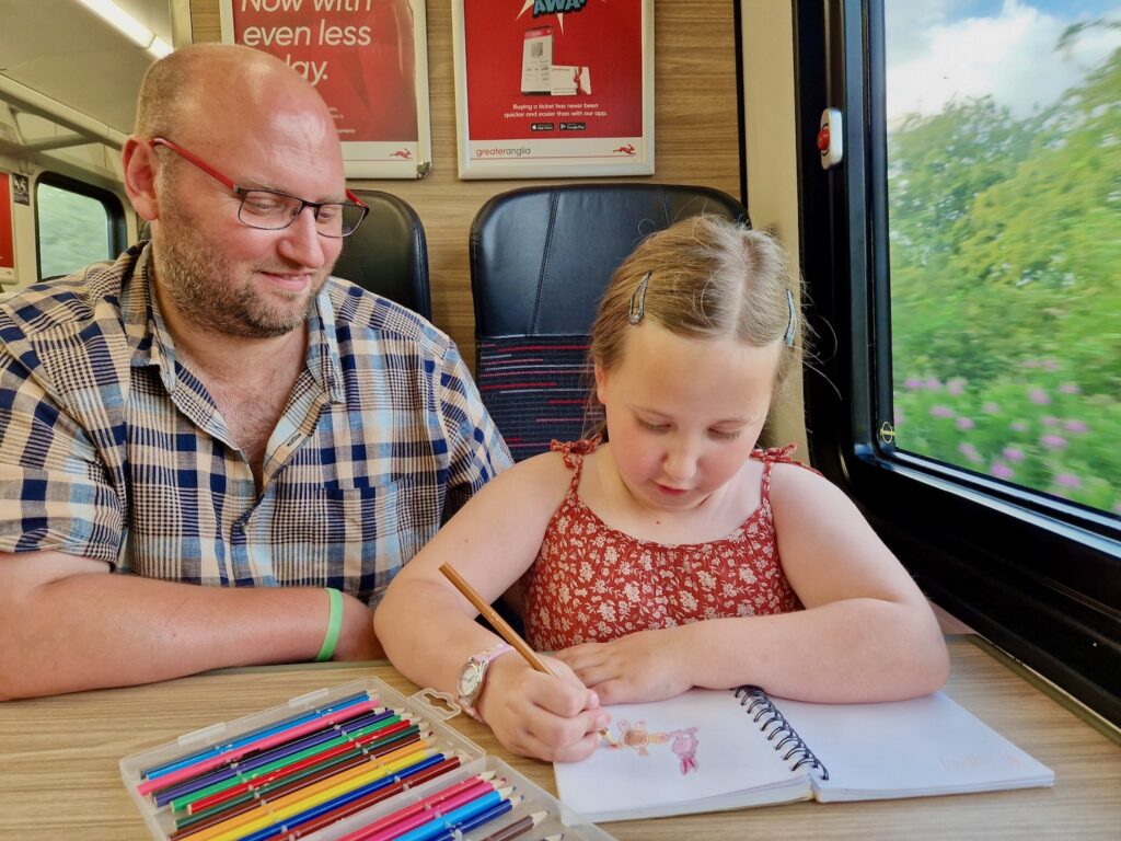 Father and daughter on the train colouring