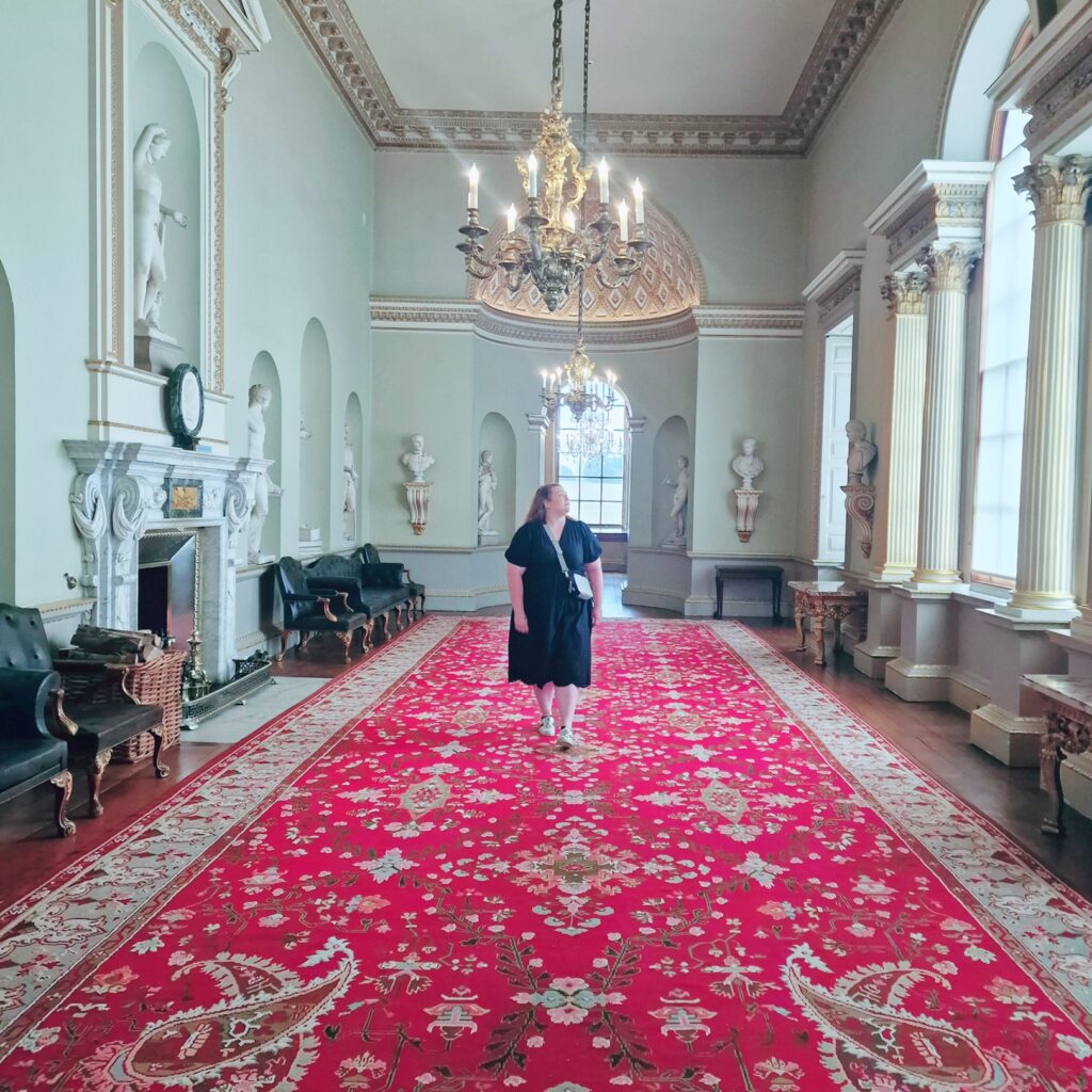Woman standing inside Holkham Hall 